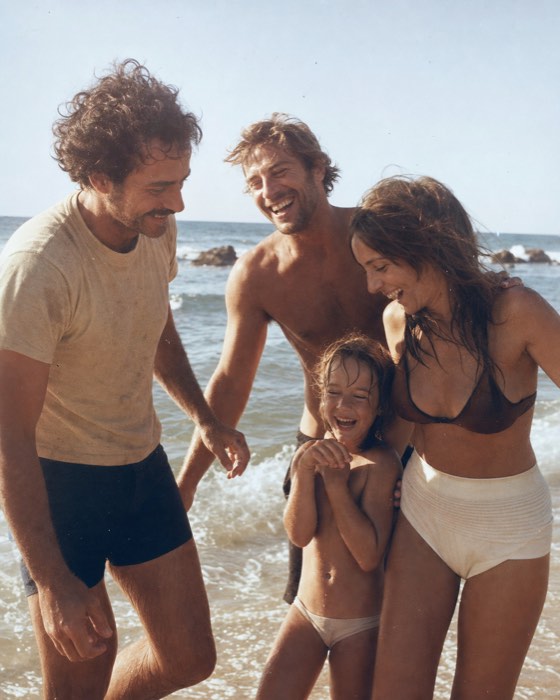 A family at the beach in warm afternoon light